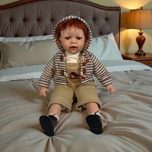 Vintage Porcelain And Cloth Boy Doll. Sitting, 23” Inches Tall.